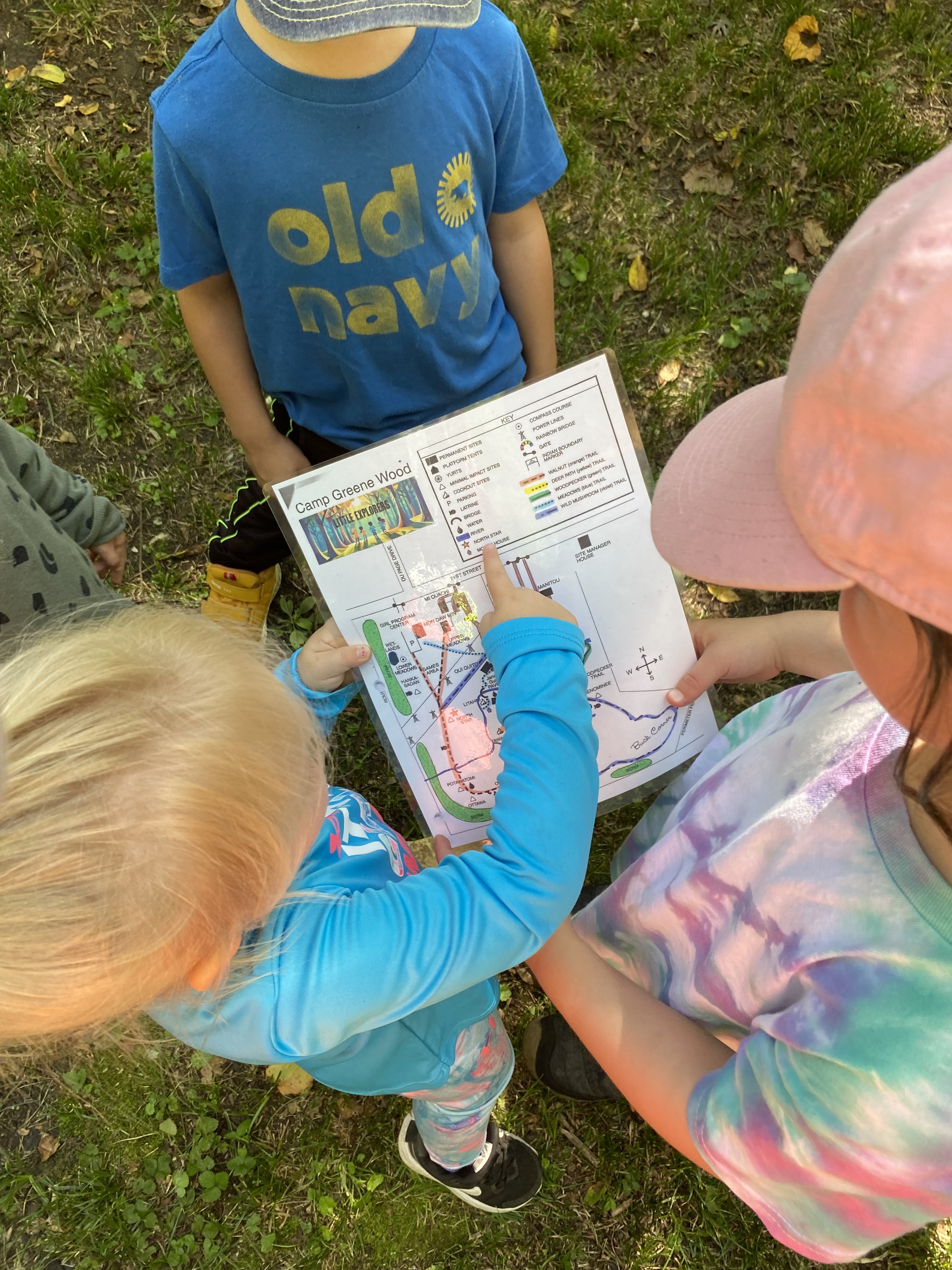 children reading a trail map